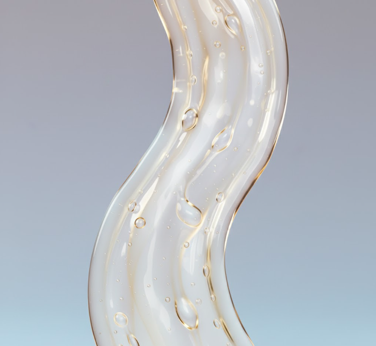 Close-up of cleansing oil texture with golden bubbles on a light blue background