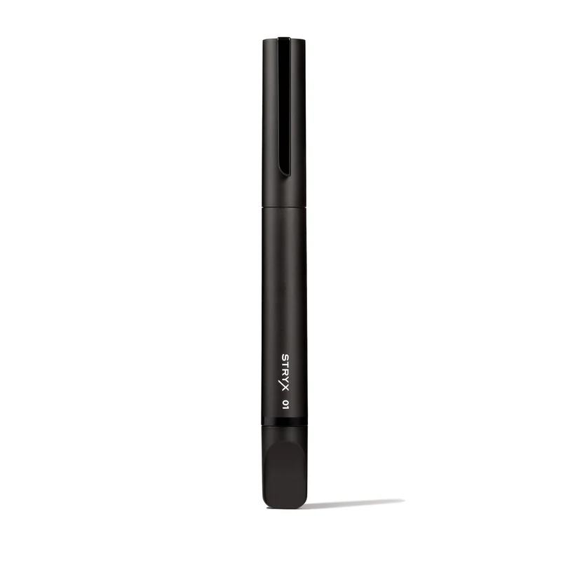 A matte black cylindrical tube labeled 'STRYX 01' stands vertically against a white background.