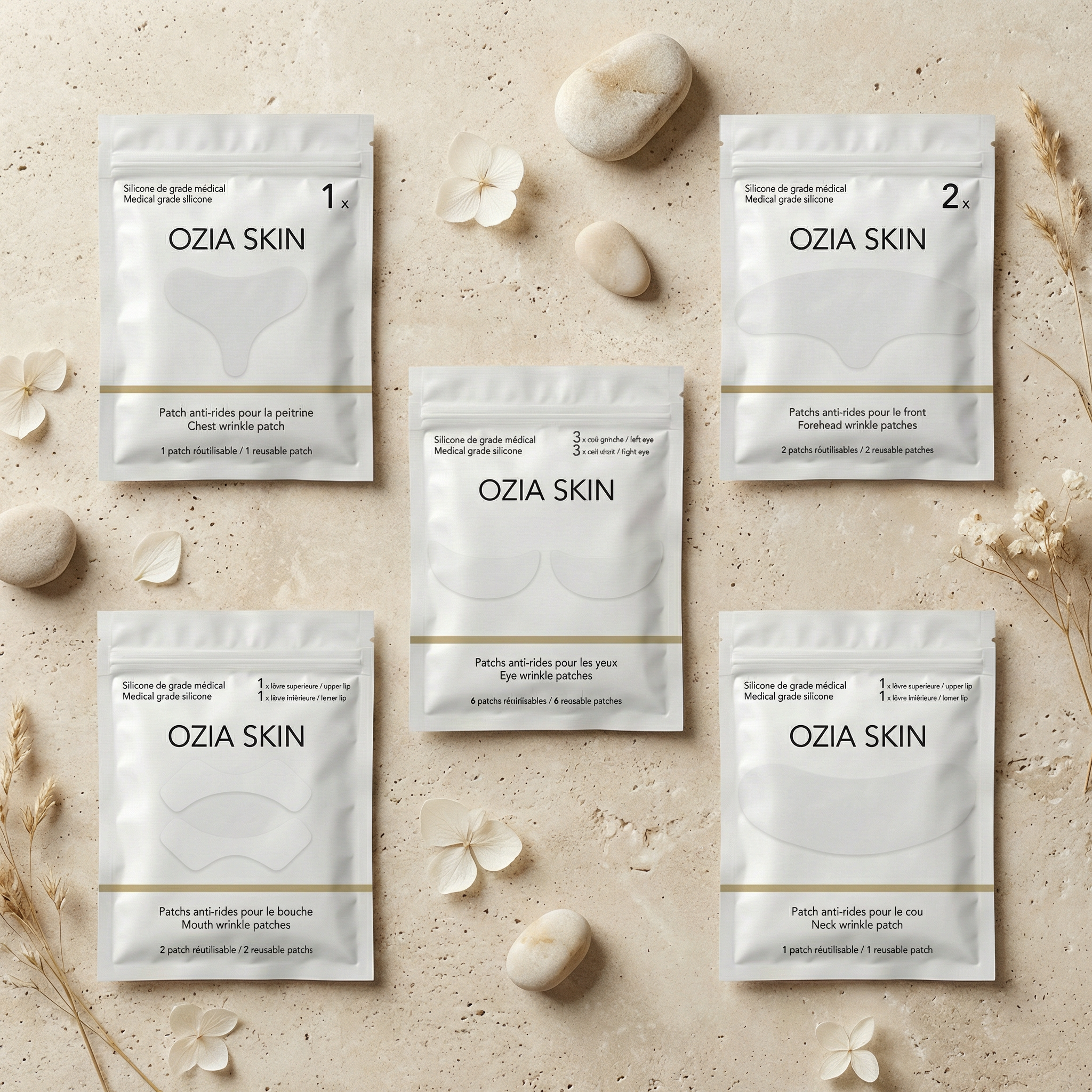 A flat lay of Ozia Skin anti-wrinkle patches arranged with small white flowers and smooth stones.