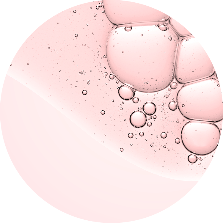 Pink liquid bubbles in a circular pattern on a light background.