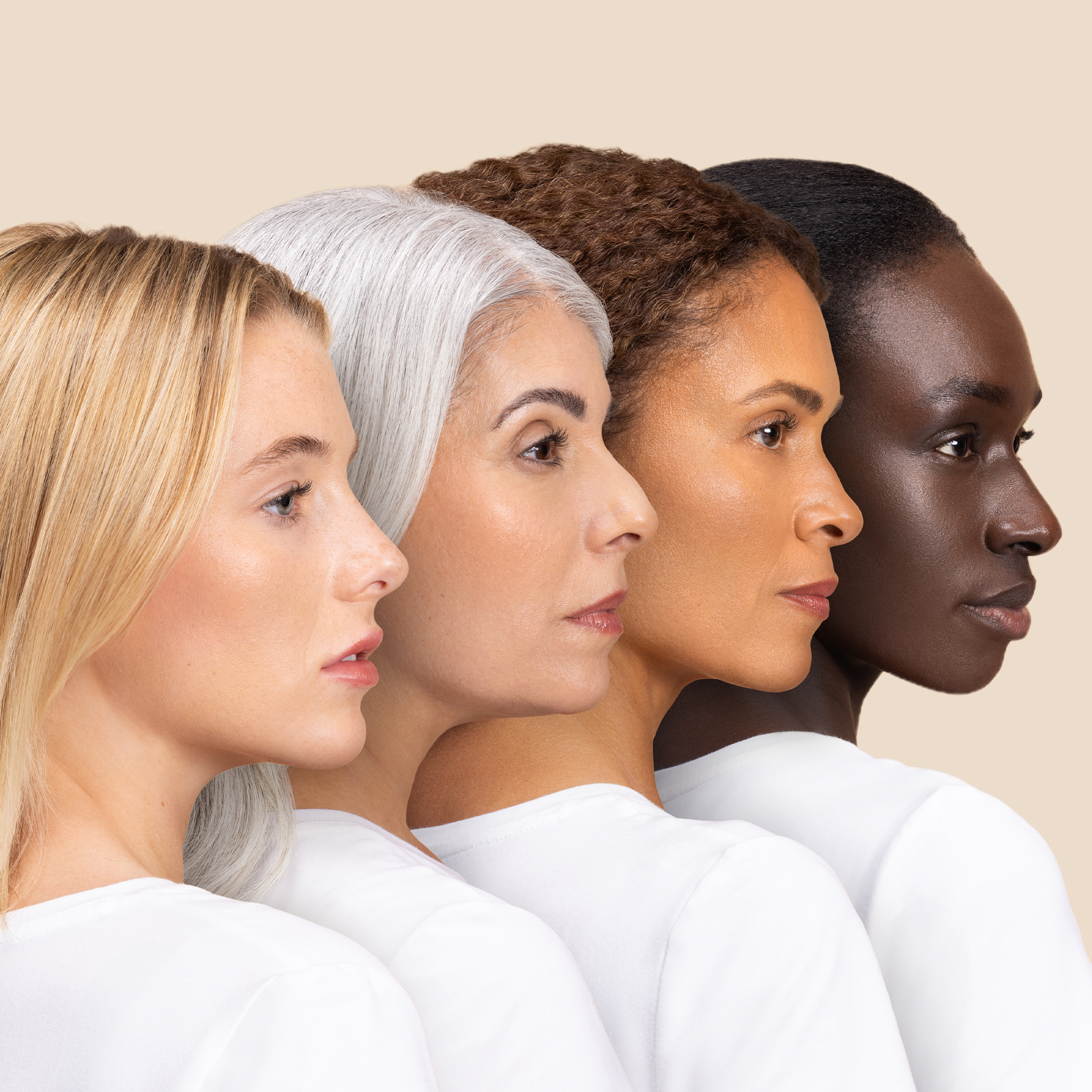 Four women with diverse skin tones and hair colors lined up in profile.