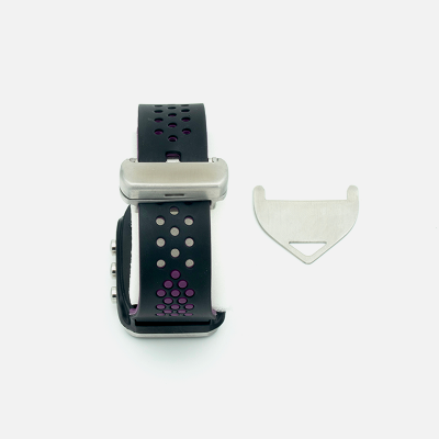 Black sports watch with purple accents and a small metal tool on a white background.