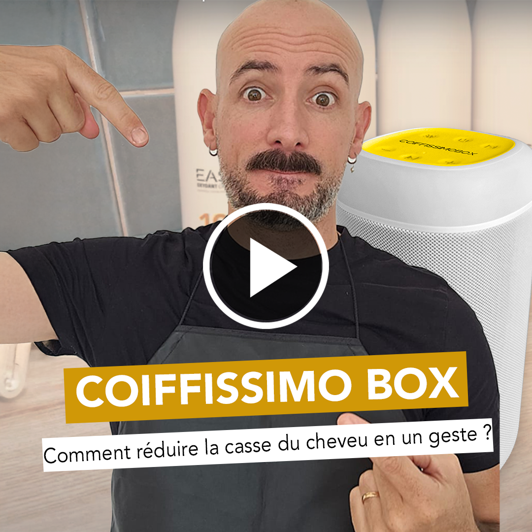 A bald man with a surprised expression points at a white device labeled 'Coiffissimo Box'.