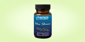 Brown supplement bottle labeled 'Blue Shroom' with a black cap on a light green background.