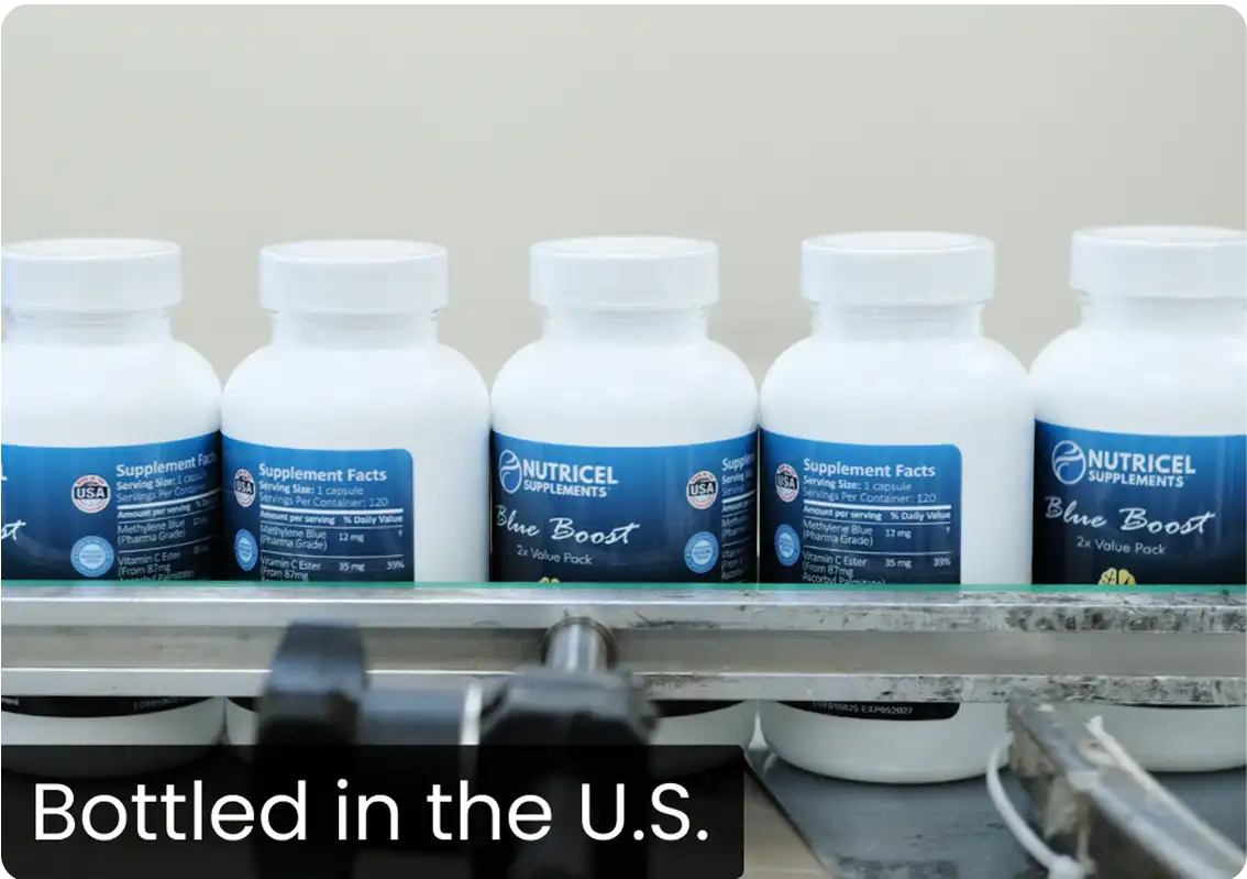 Row of white supplement bottles on a conveyor belt.