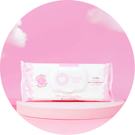 A package of MUSC Intime intimate wipes sits on a pink pedestal against a pink, cloudy background.