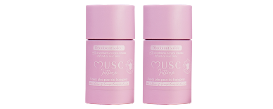Two pink tubes of Musc Intime solid deodorant against a white background.