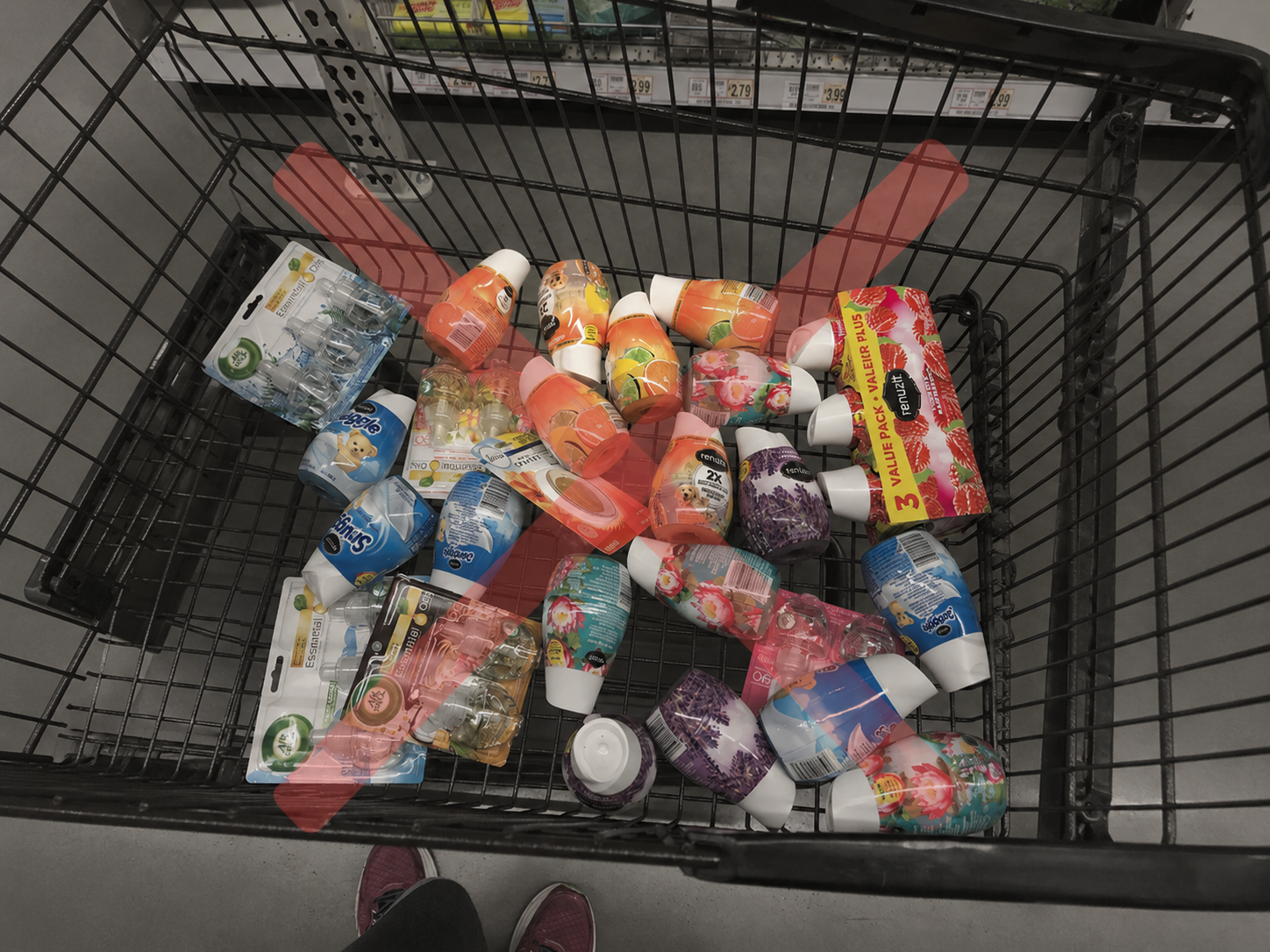 A top-down view of a shopping cart filled with air fresheners, with a large red X over them.