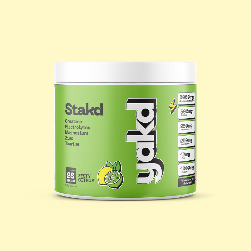 A tub of Stakd Zesty Citrus creatine and electrolyte powder against a pale yellow background.
