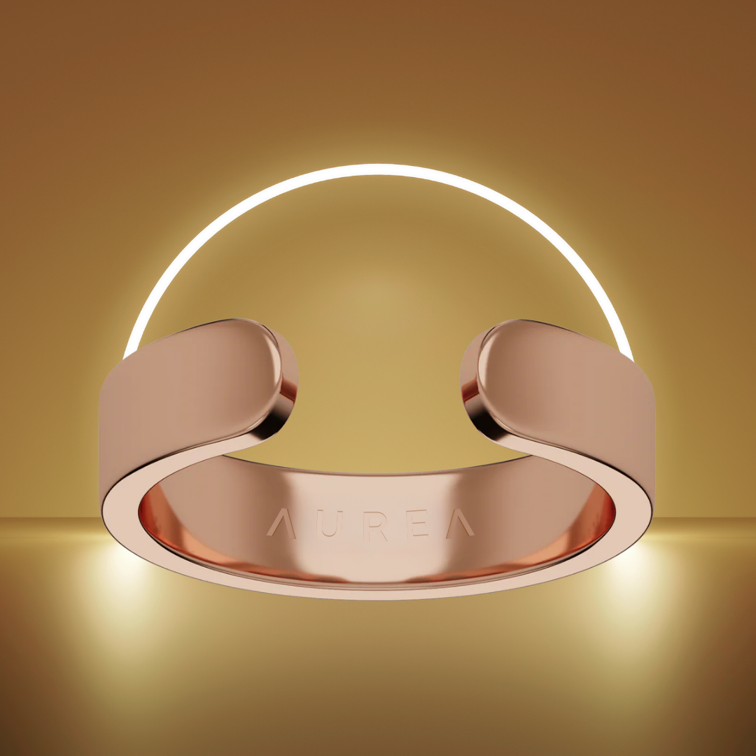 Rose gold ring with 'Aurea' engraved, set against a glowing light arc.