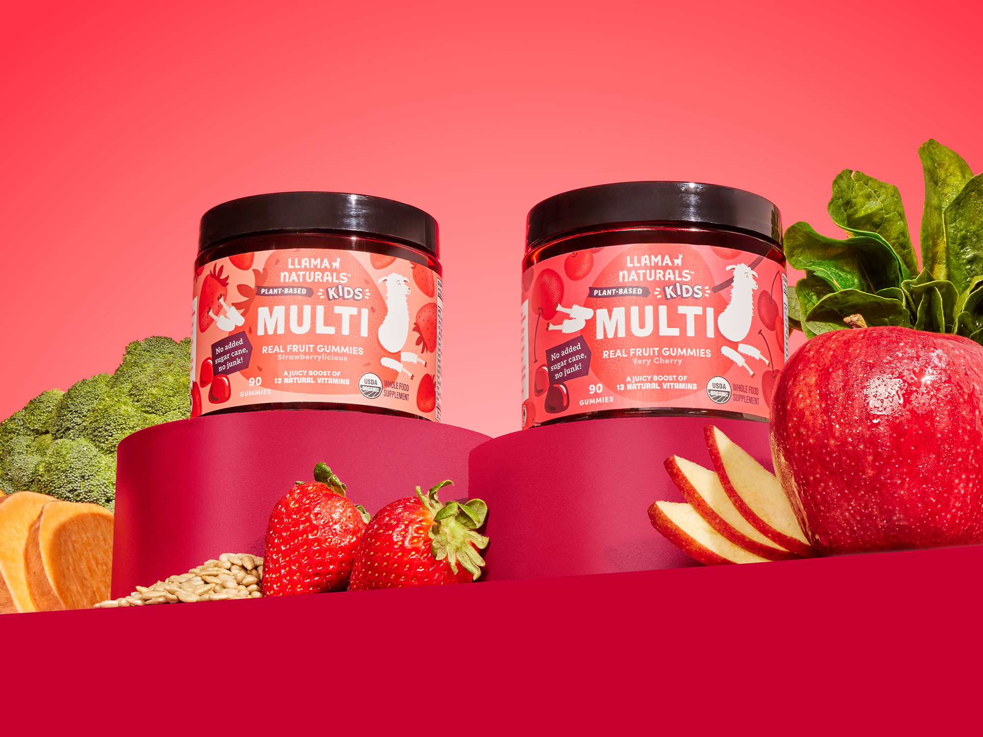 Two jars of fruit gummies with fresh fruits and vegetables.
