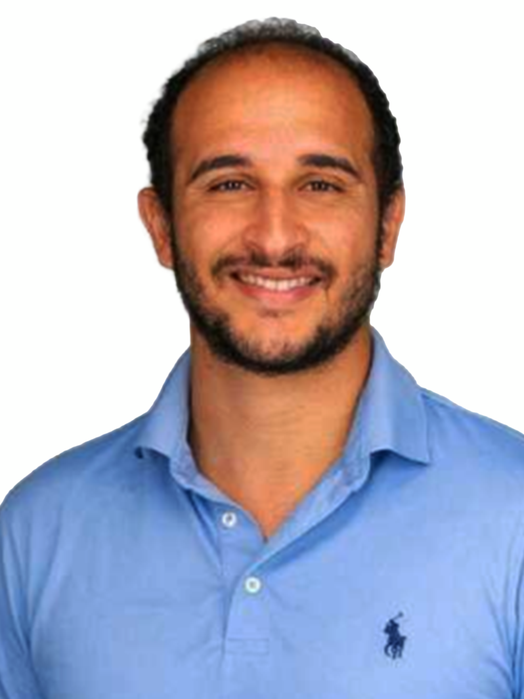 A headshot of a smiling man with a beard, wearing a light blue polo shirt.