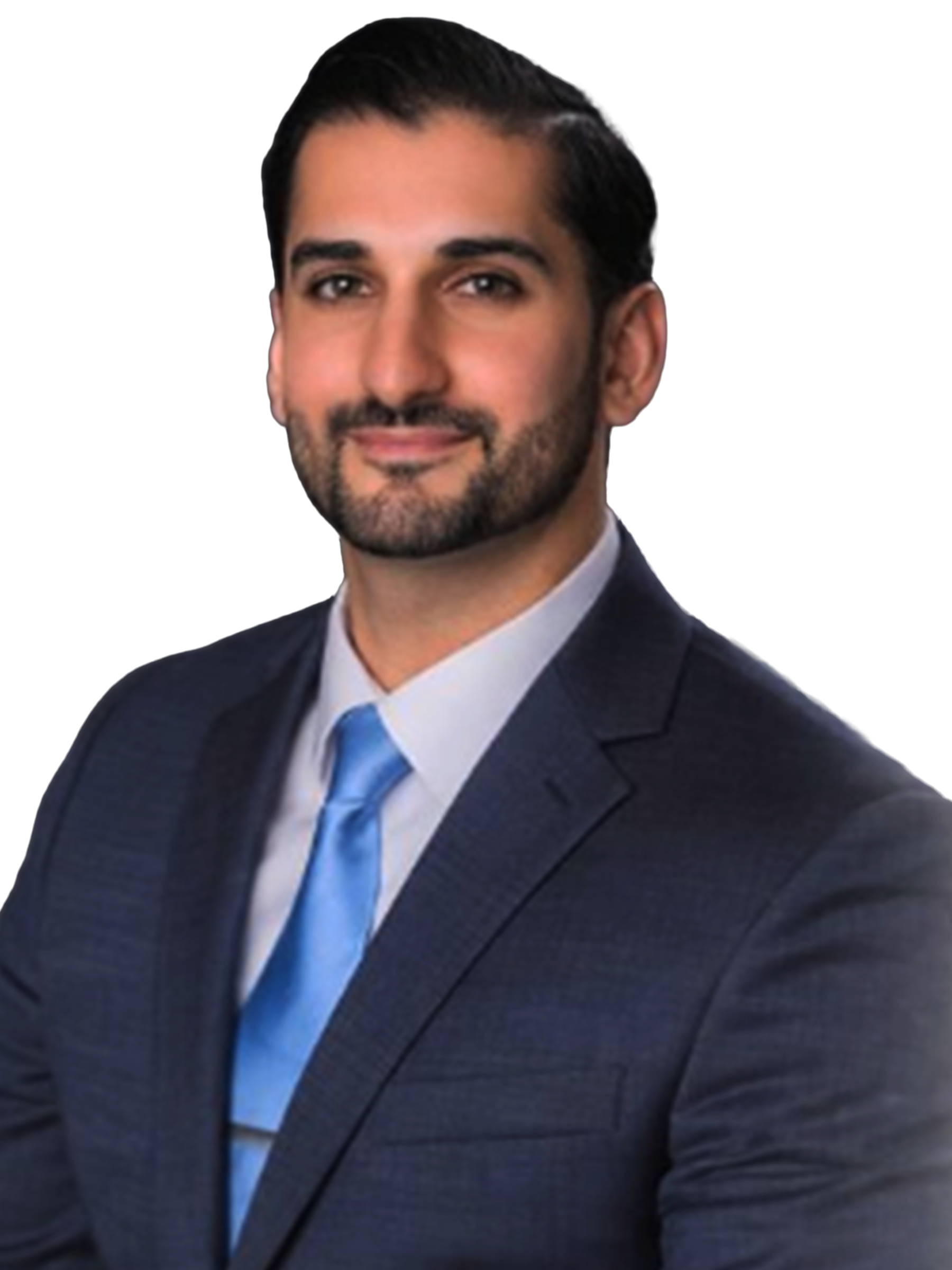 A man with dark hair and a beard, wearing a blue suit and tie, smiles at the camera.