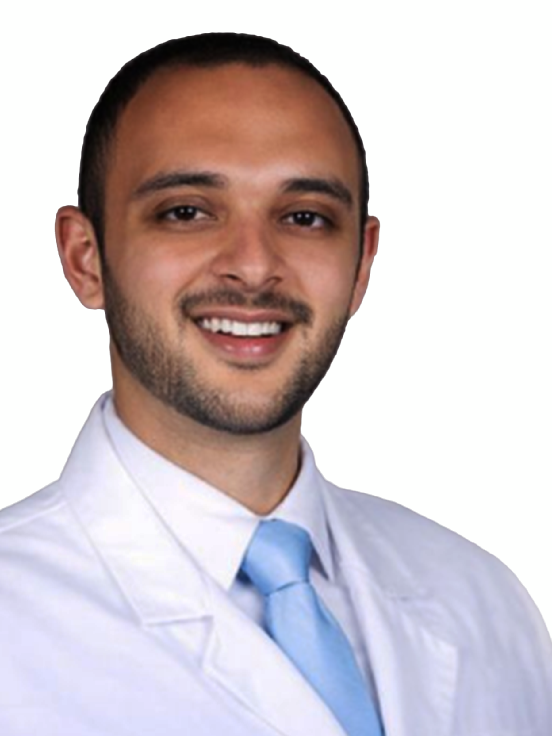 A headshot of a smiling man with a beard, wearing a white lab coat and a light blue tie.