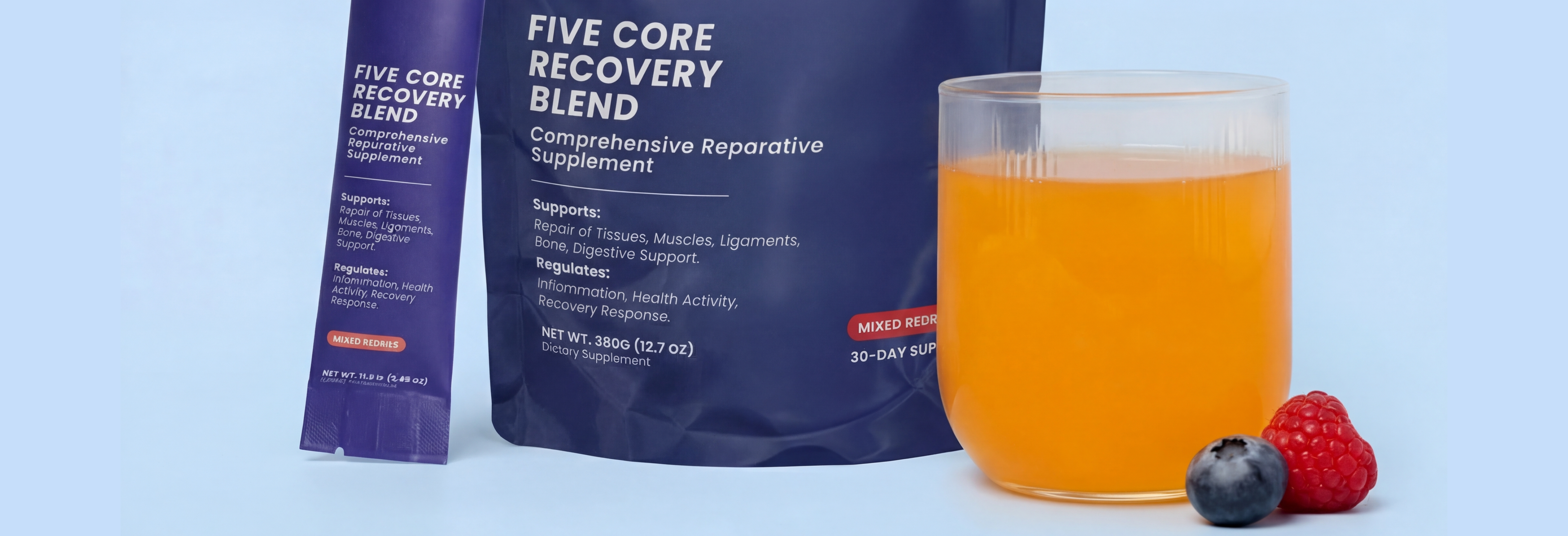 A pouch and sachet of Five Core Recovery Blend next to a glass of the mixed drink and berries.