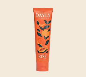 An orange tube of DAYLY RISE body cream with illustrations of citrus fruit and papaya.