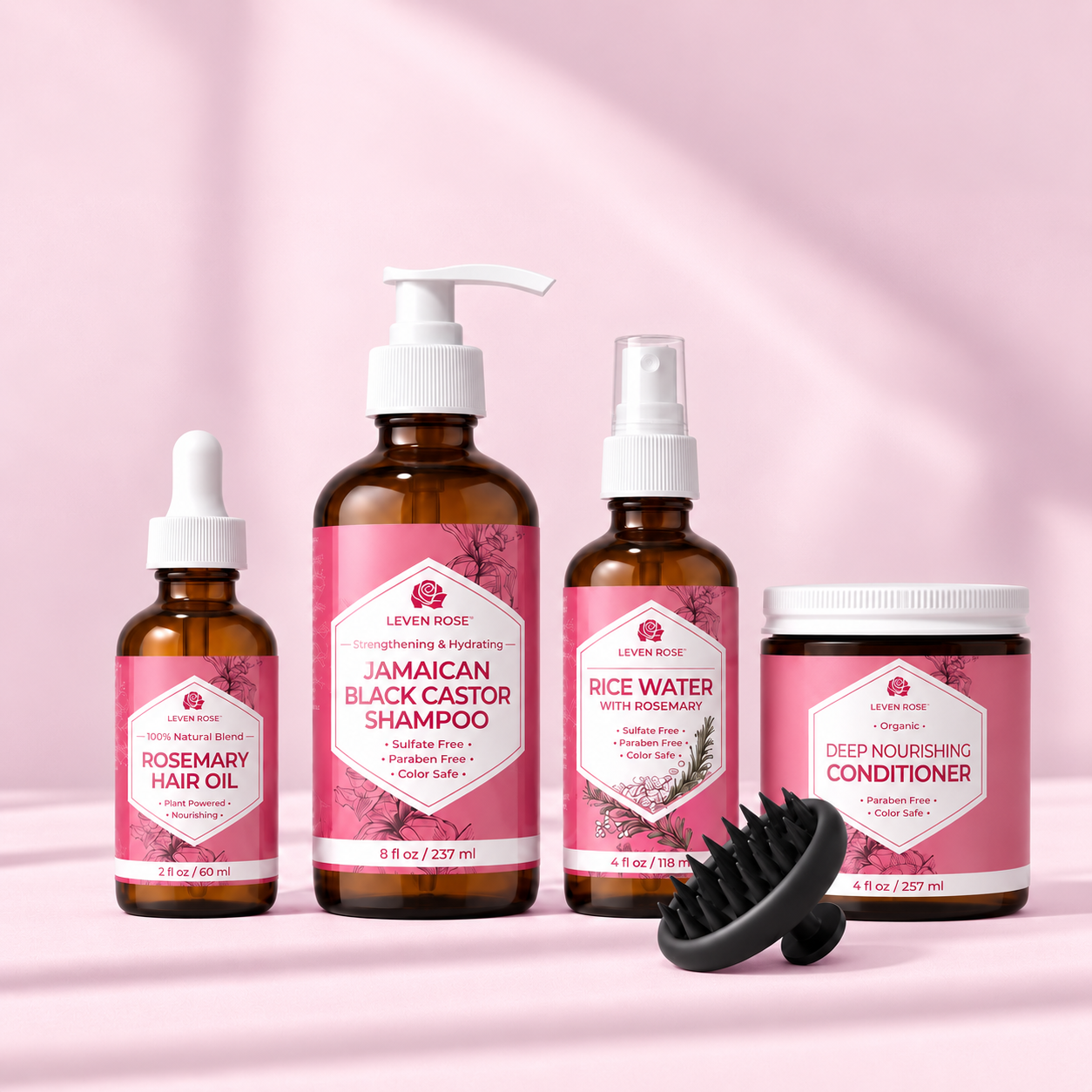 A set of four Leven Rose hair products, including shampoo, conditioner, oil, and spray, with a scalp massager.