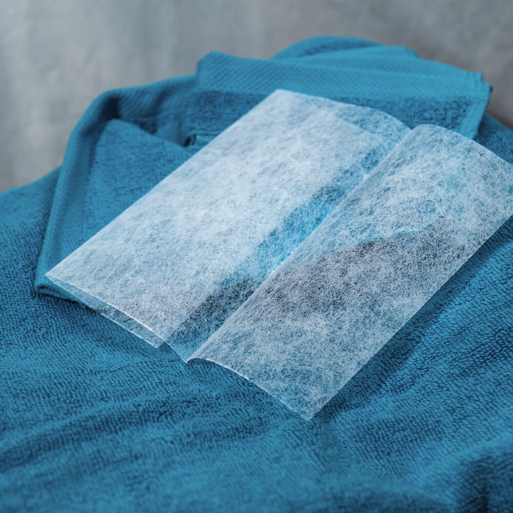 White textile sheets on blue towels.