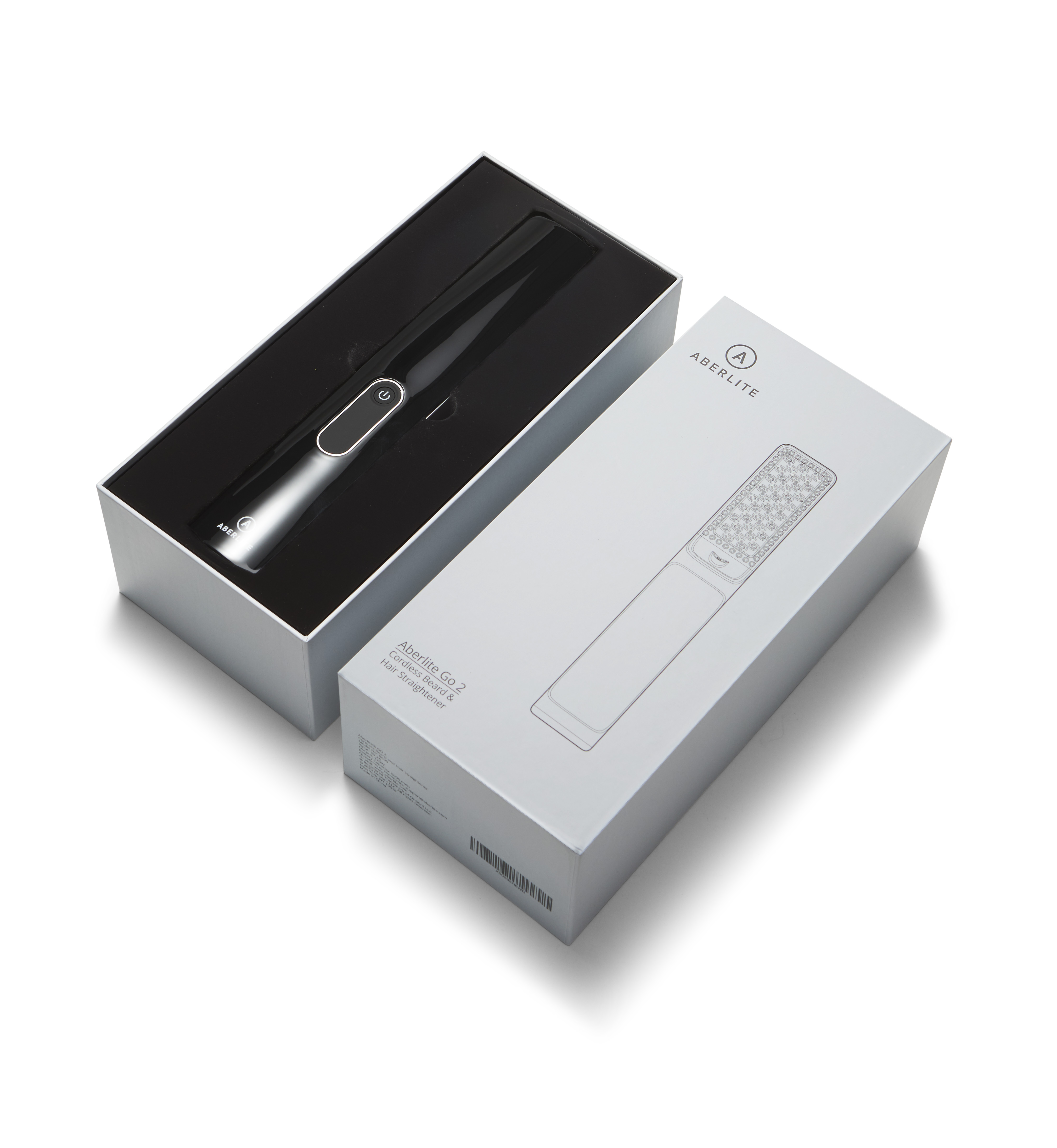 Black hair straightener in an open box next to its packaging.
