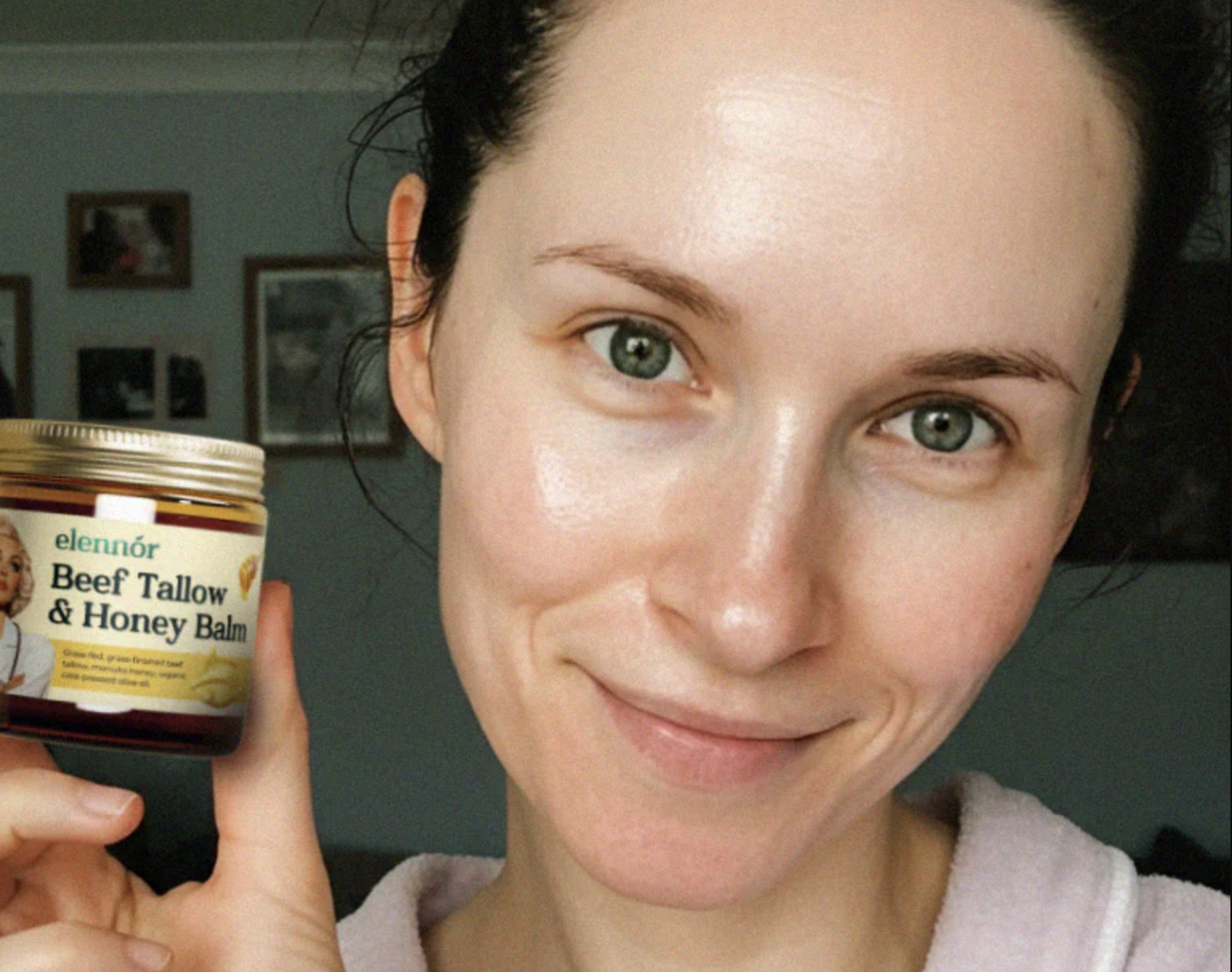 A person holding a jar of 'Beef Tallow & Honey Balm' with a smile.