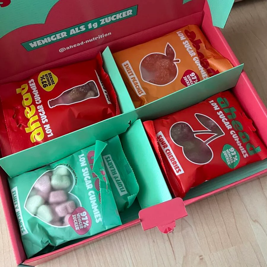 Box of assorted low sugar gummy candy packs.