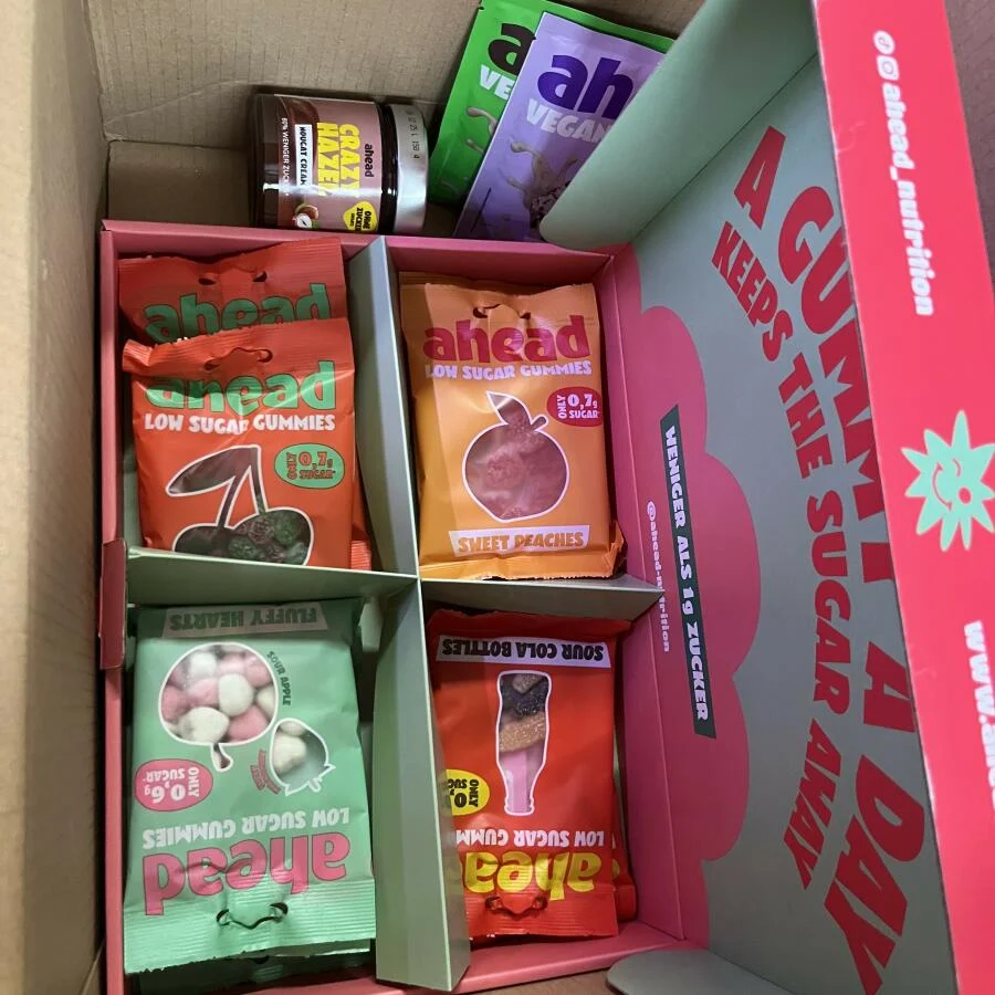 Box containing various low sugar gummy candy packs.