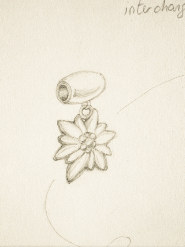 Pencil sketch of a flower-shaped pendant with a loop attachment.