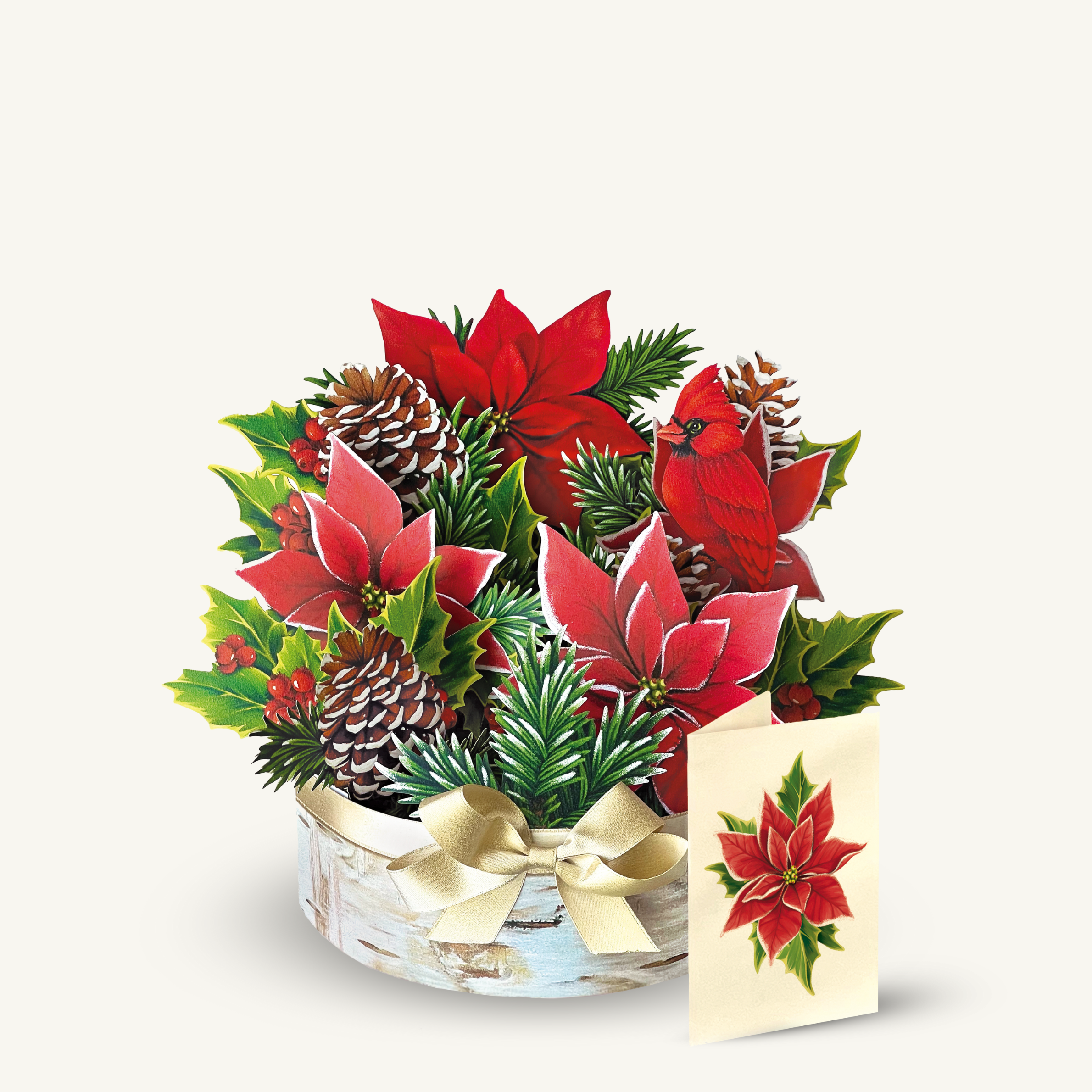Festive arrangement with red flowers, pinecones, and a red bird, alongside a card with a poinsettia.
