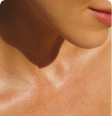 Close-up of a person's neck and lower face with natural lighting.