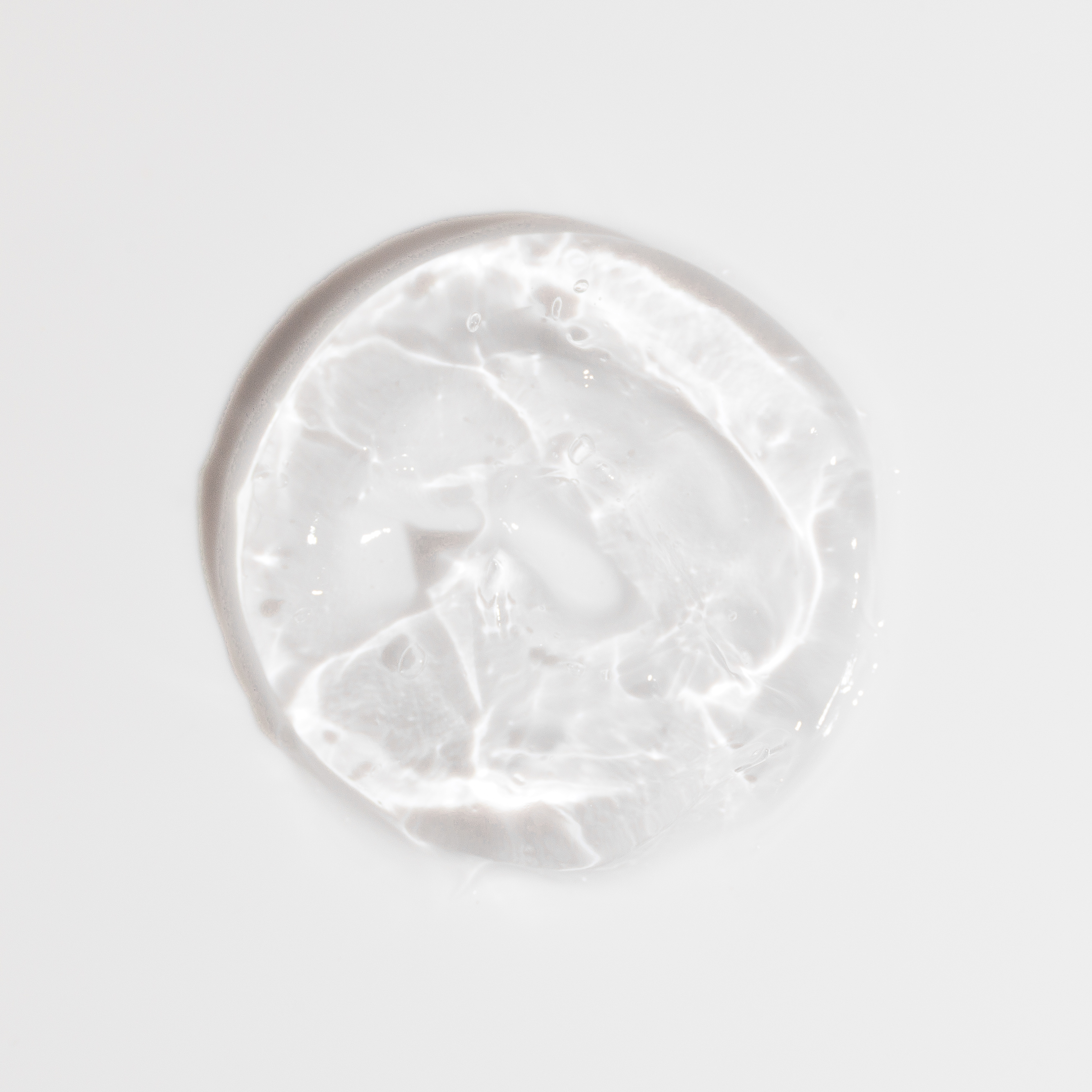 Clear gel blob on a white background.