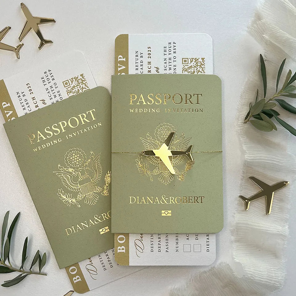 Wedding invitations designed as passports with gold airplane decorations.