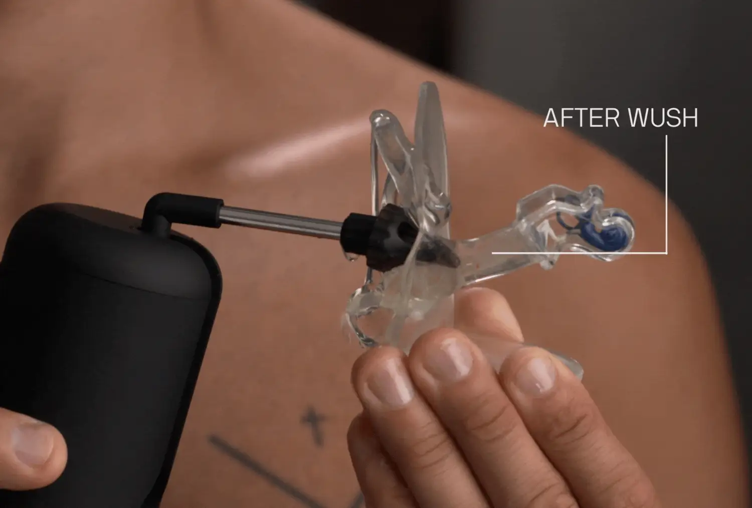 Person holding a clear device with a black nozzle labeled 'After Wush.'