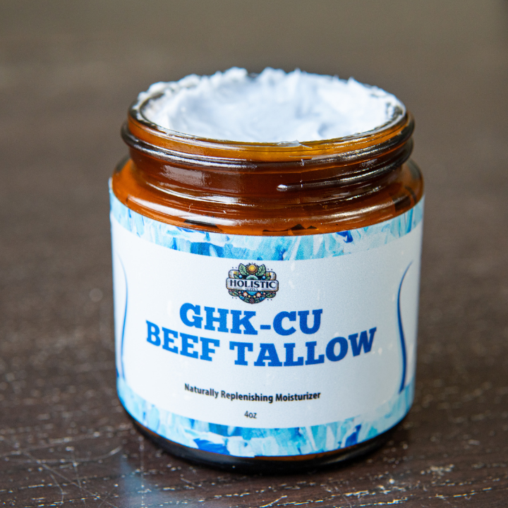 Open jar of GHK-CU Beef Tallow moisturizer on a table.