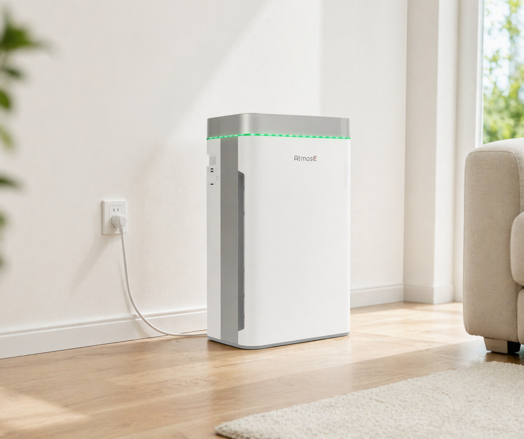 A white and grey Atmos air purifier with a green light on, standing on a wood floor.
