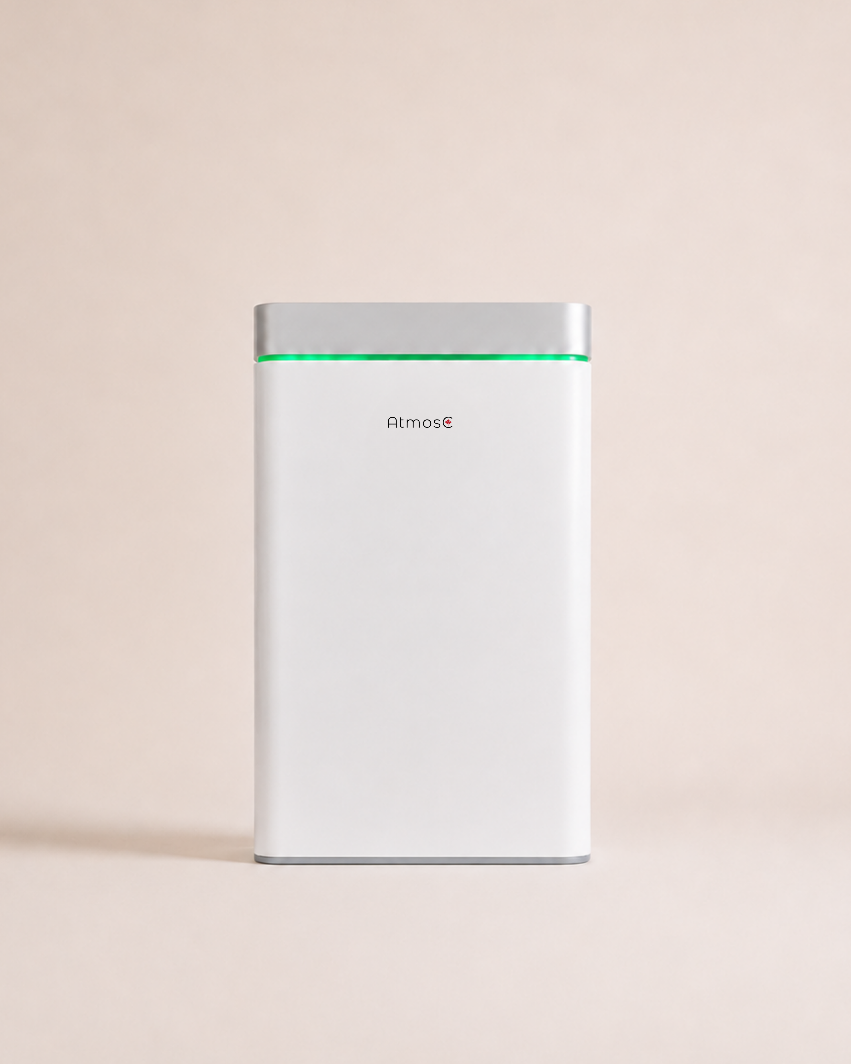 A white electronic device with a silver top, a green light, and the brand name Atmos on the front.