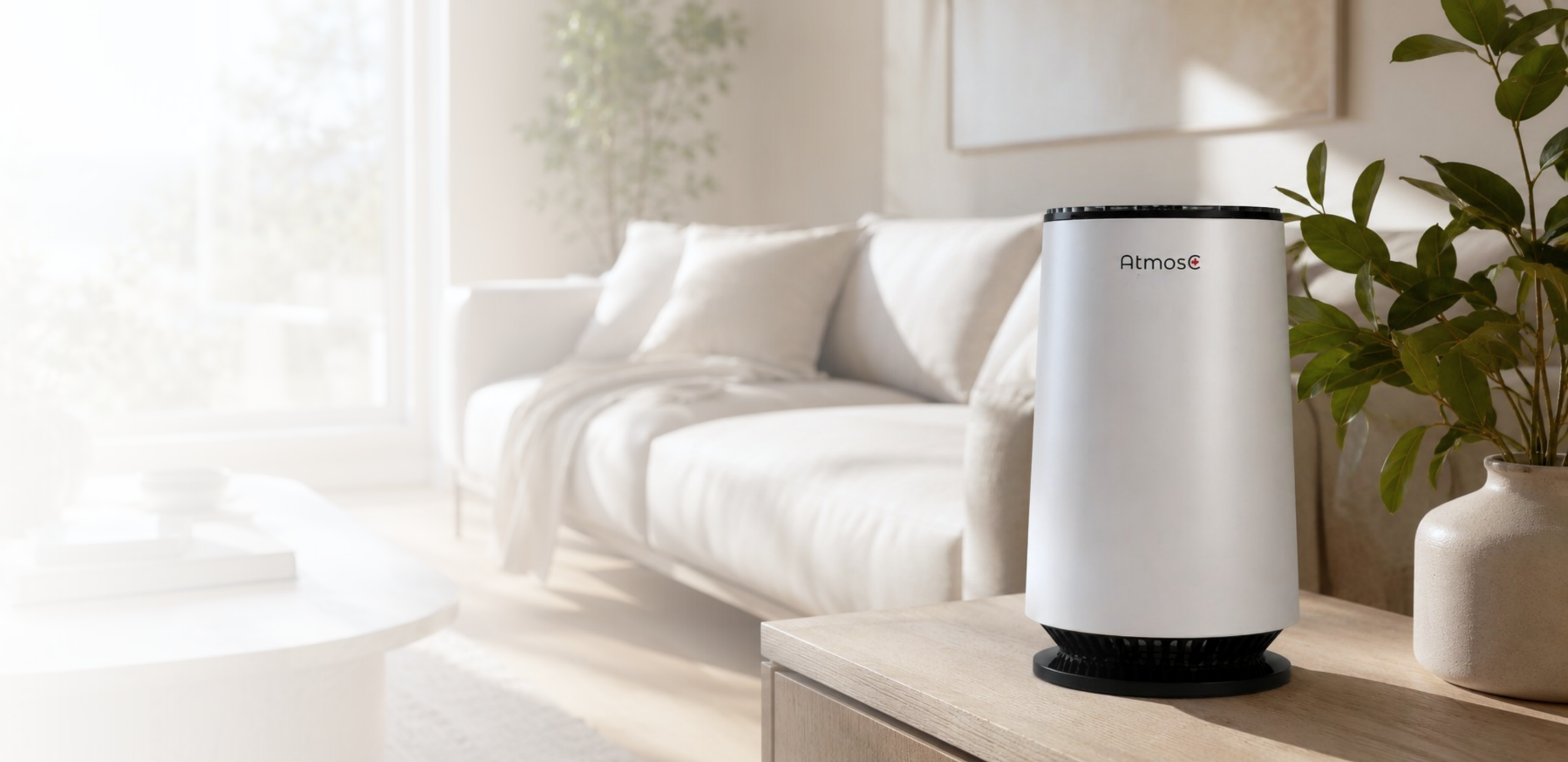 A white Atmos air purifier sits on a wooden cabinet in a brightly lit, modern living room.