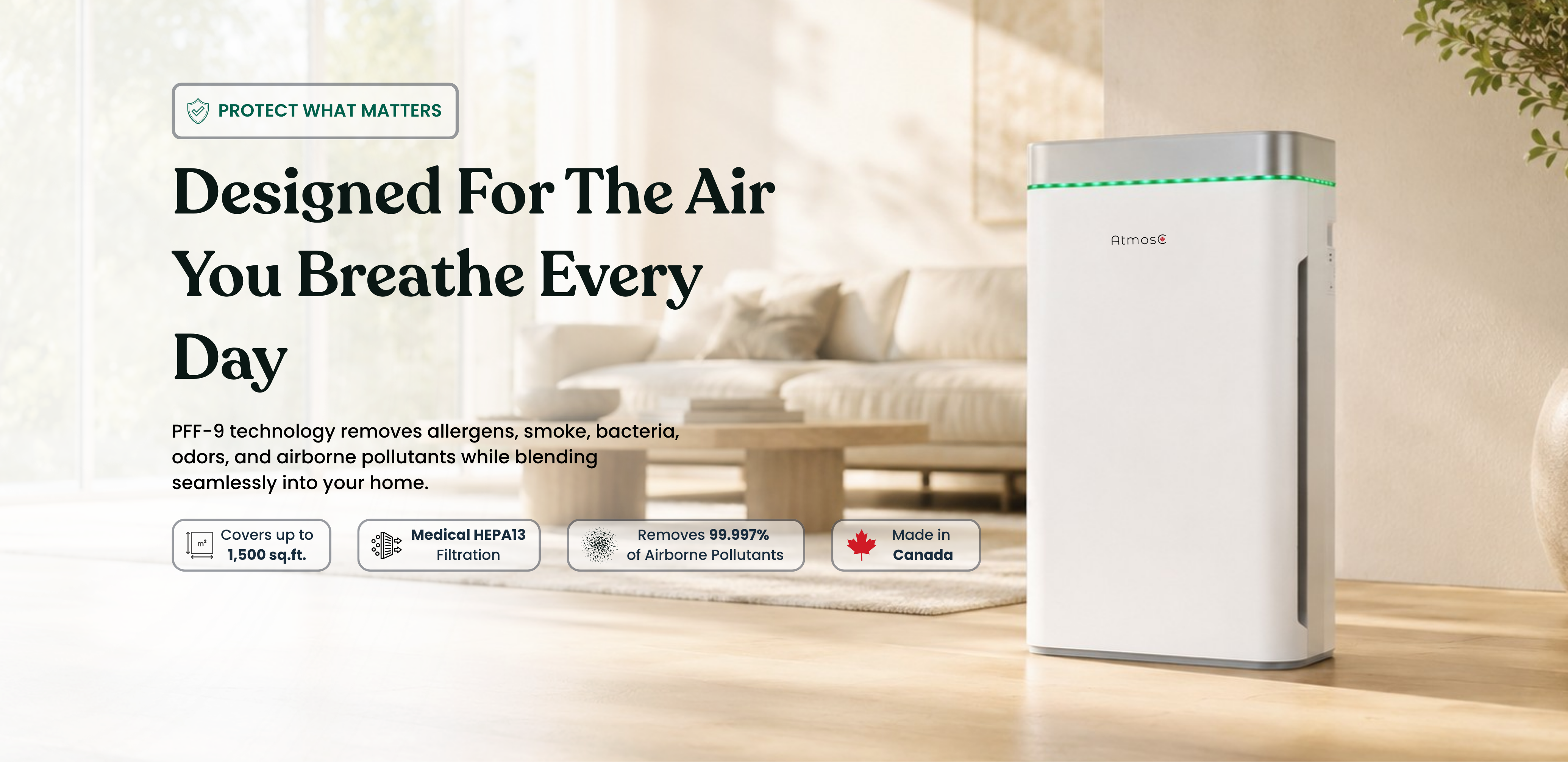 A white Atmos air purifier sits on a wood floor in a modern, brightly lit living room.