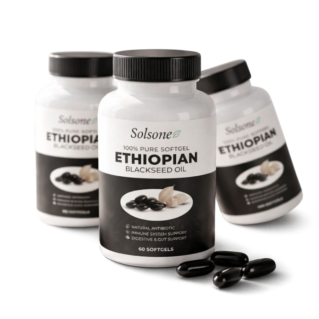 A black and white photo of three bottles of Solsone Ethiopian Blackseed Oil with loose softgels.