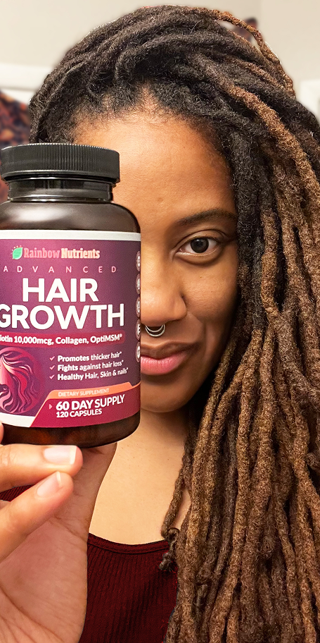 Person holding a bottle of hair growth supplements.
