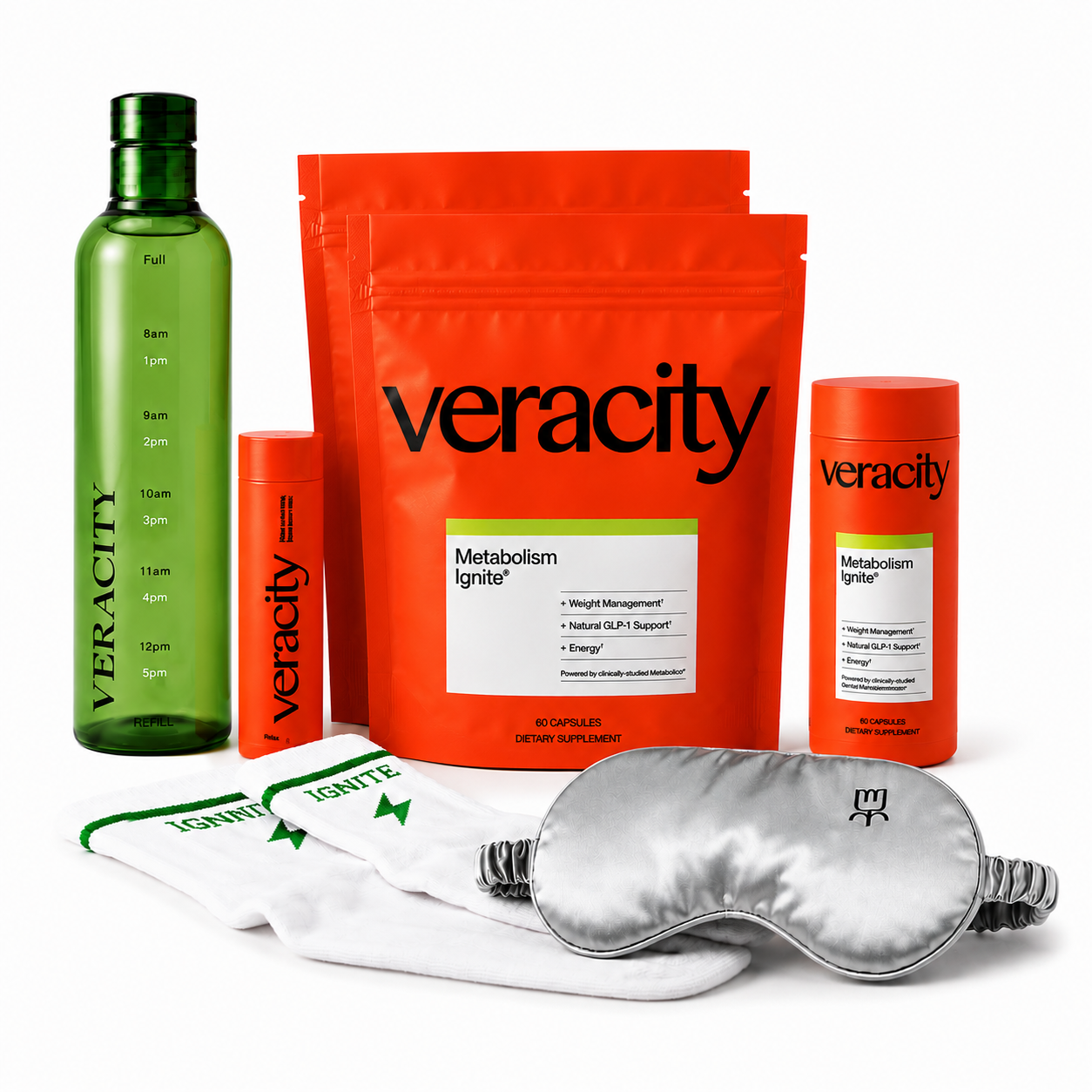 A smiling woman in an orange shirt sits behind a table displaying Veracity brand wellness products.