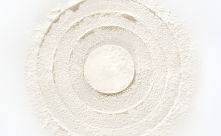 Concentric circles of white powder on a flat surface.