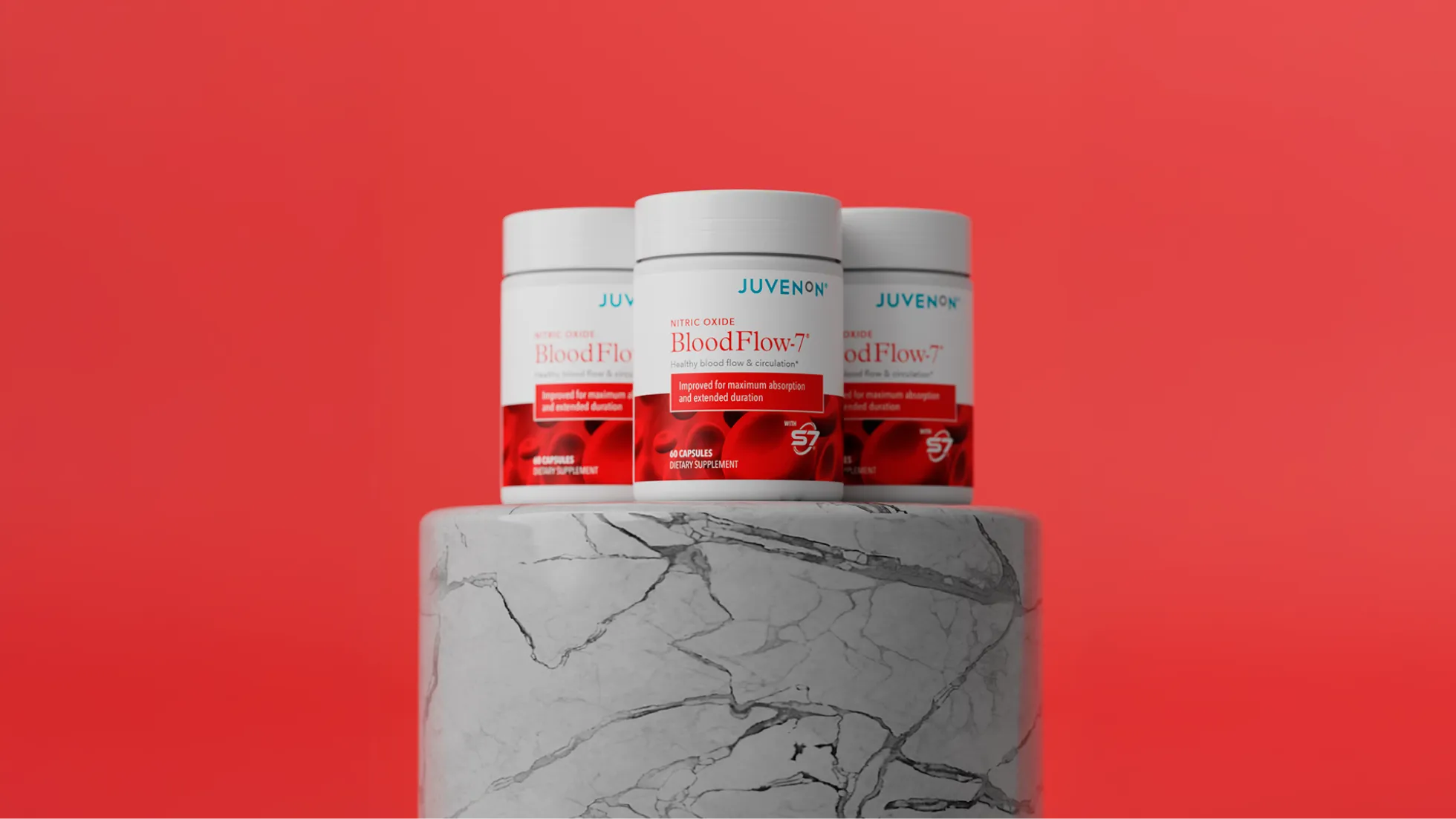 Three supplement bottles on a marble pedestal against a red background.