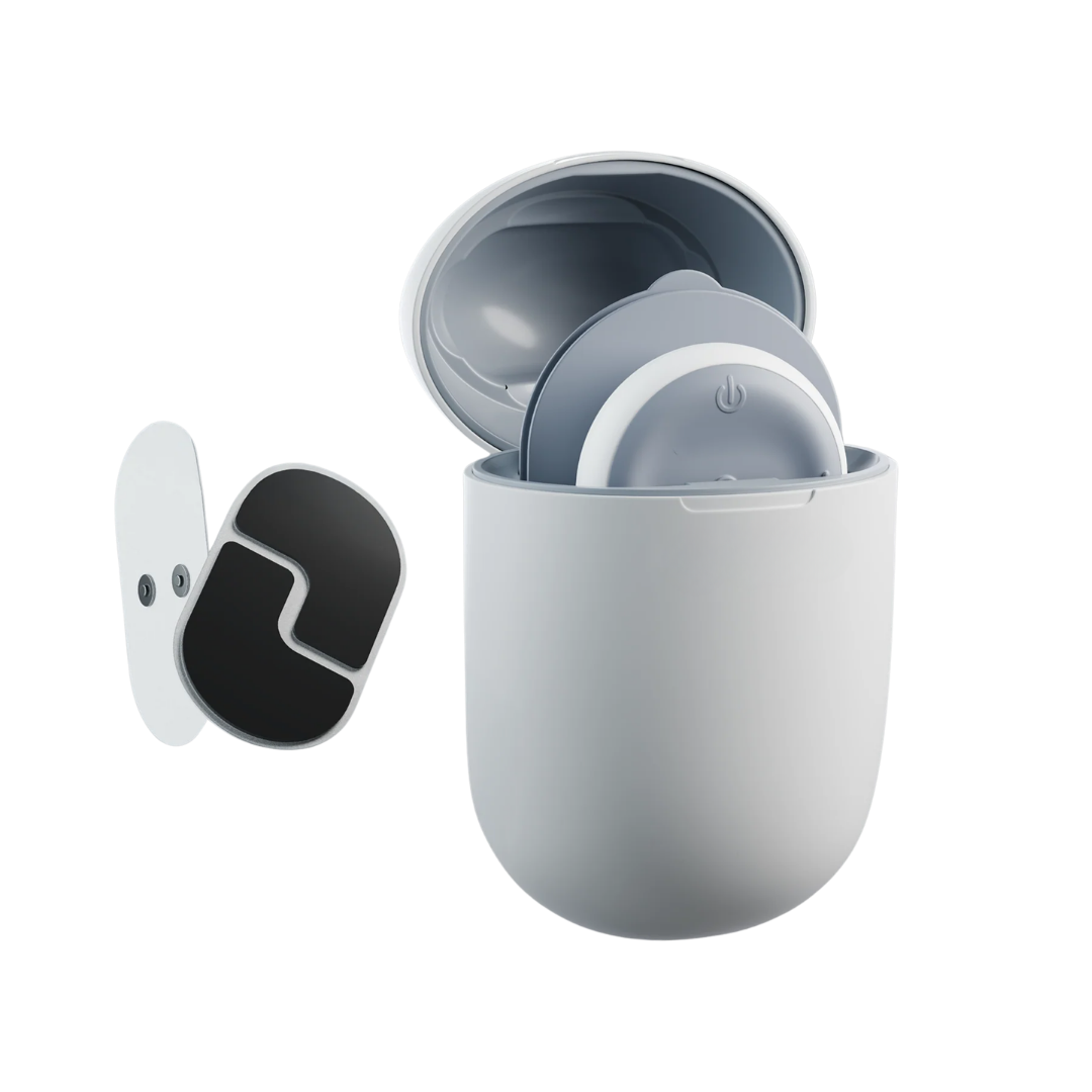 A white charging case with two circular grey devices inside, next to a separate black and white pad.