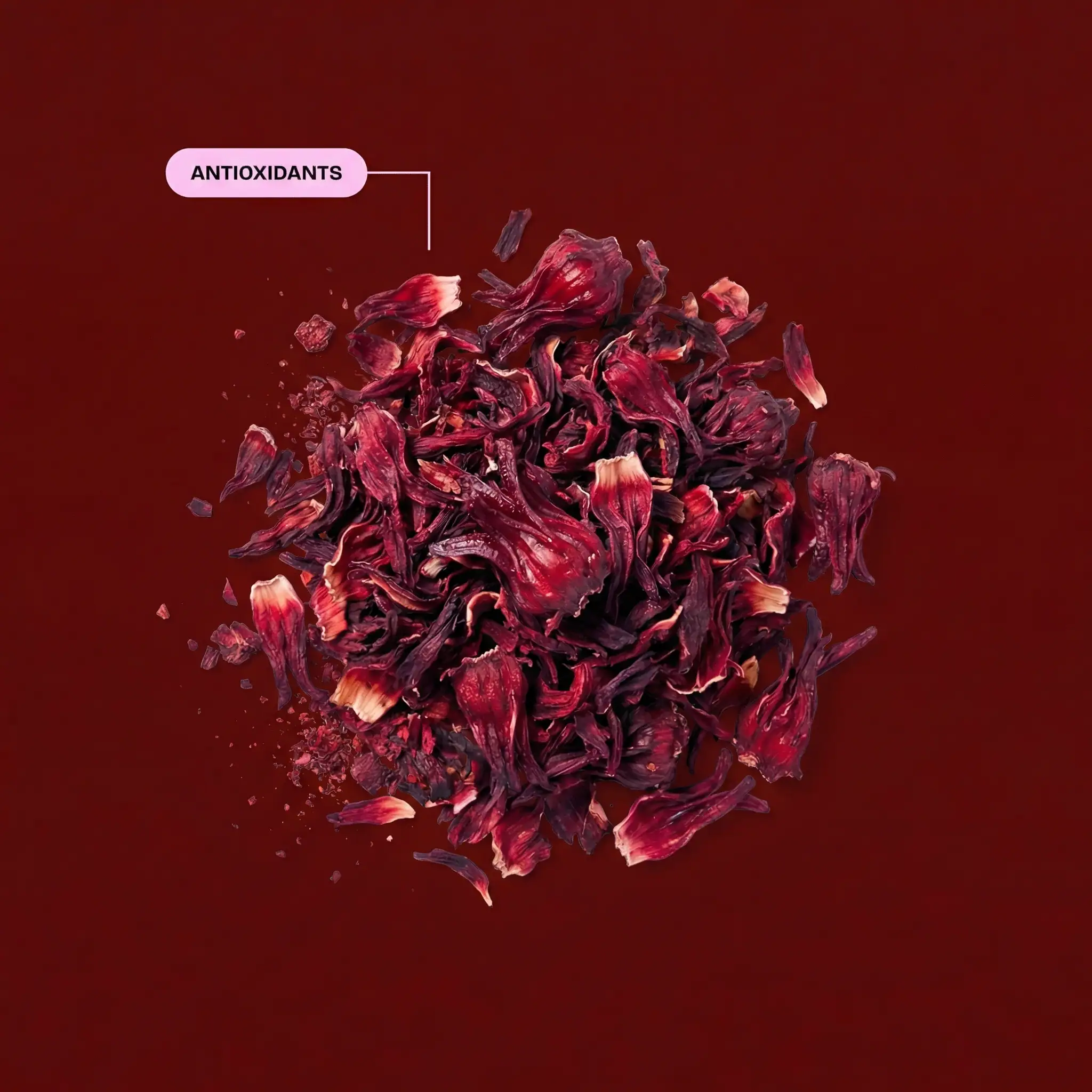 A top-down view of dried red hibiscus flowers on a dark red background, with an 'ANTIOXIDANTS' label.