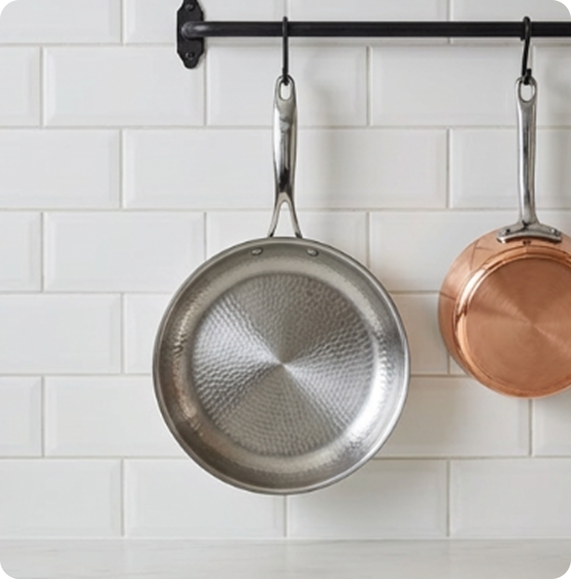 A close-up of a Lurosa stainless steel pan with a textured, pebble-patterned interior cooking surface.