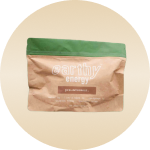 A brown and green package labeled 'earthy energy' against a beige background.
