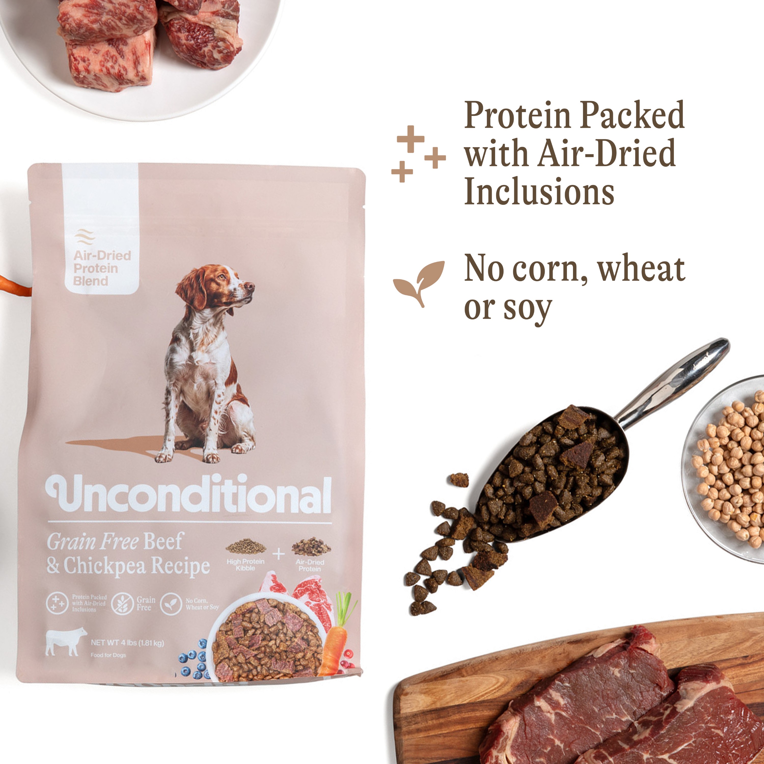 A bag of Unconditional dog food with a scoop of kibble, raw beef, and chickpeas.