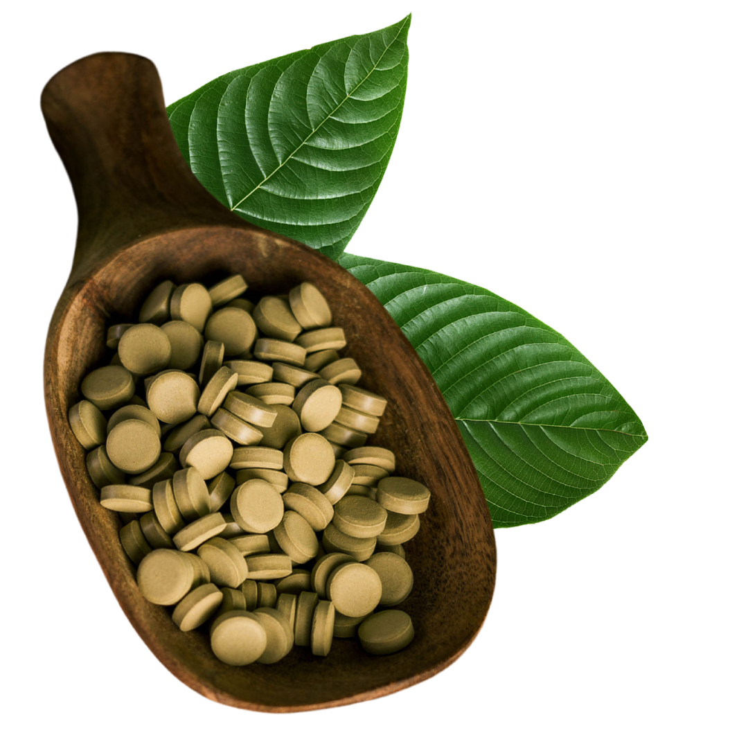 Wooden scoop with green tablets and two green leaves.