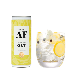 A can of alcohol-free gin and tonic next to a glass with lemon slices and ice.