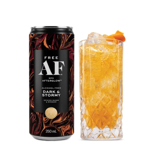 A can of alcohol-free Dark & Stormy next to an ice-filled glass with orange peel.